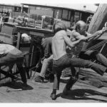 Four men working on a dock.